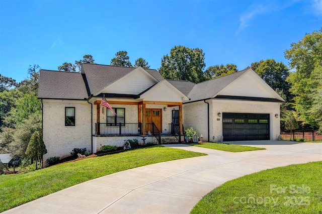 modern farmhouse style home featuring a front yard, brick siding, a garage, and driveway