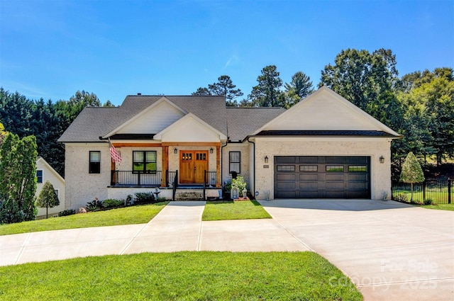 modern farmhouse with brick siding, a front lawn, fence, a garage, and driveway