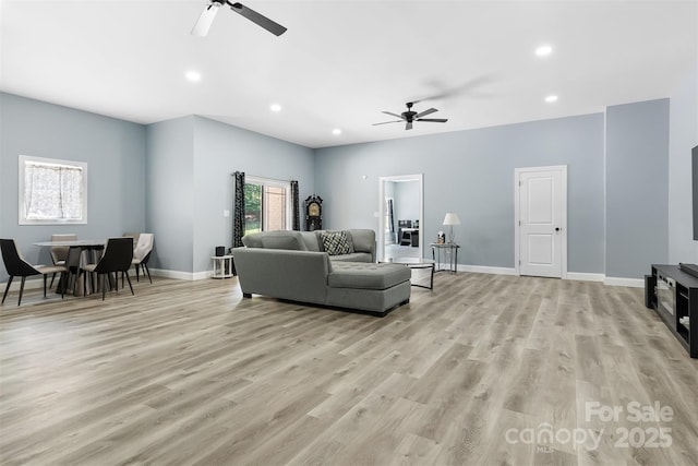 living room featuring recessed lighting, baseboards, light wood-style floors, and ceiling fan