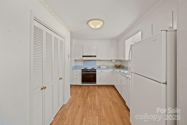 kitchen featuring freestanding refrigerator, under cabinet range hood, range with electric stovetop, white cabinetry, and light wood-type flooring