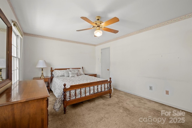 bedroom with a ceiling fan, carpet, baseboards, and ornamental molding