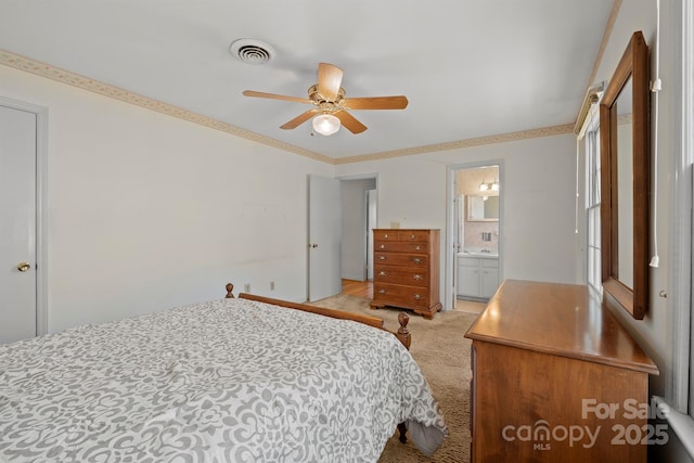 bedroom with ceiling fan, light colored carpet, visible vents, and connected bathroom