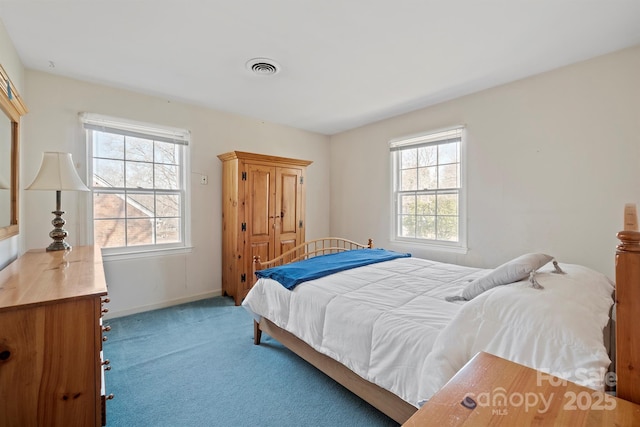 carpeted bedroom with visible vents and baseboards