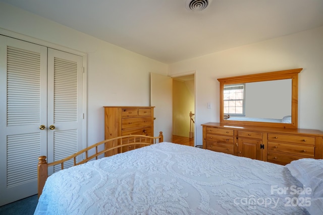 bedroom with visible vents and a closet