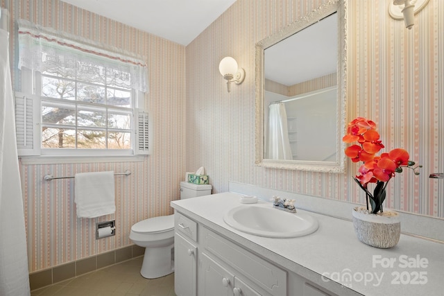 bathroom featuring vanity, a shower with curtain, wallpapered walls, tile patterned floors, and toilet