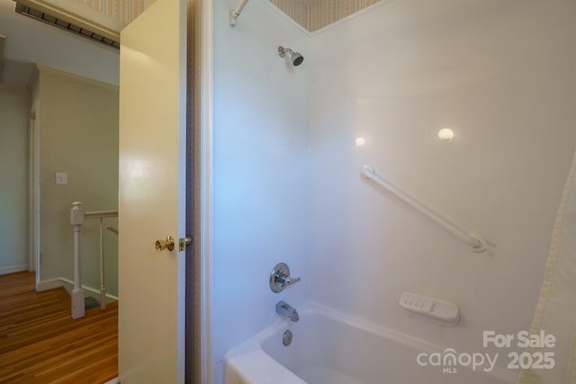 bathroom featuring bathing tub / shower combination and wood finished floors