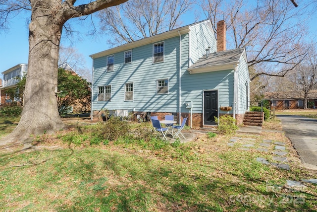 back of property with a chimney