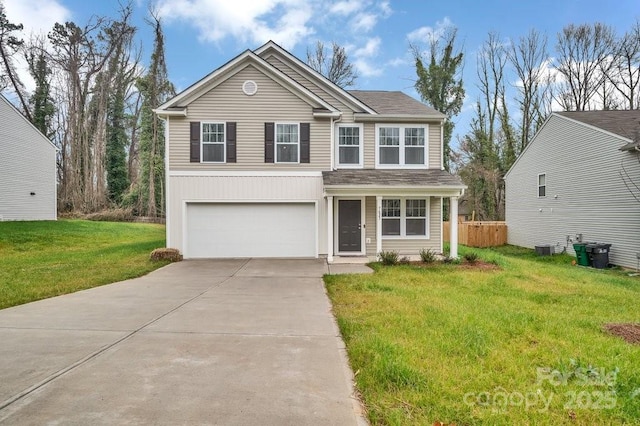 traditional-style house with a front lawn, fence, a garage, and driveway