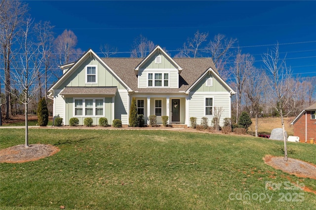 craftsman-style house featuring roof with shingles, board and batten siding, and a front yard