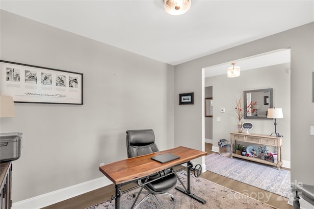 office area with wood finished floors and baseboards