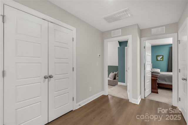 bedroom featuring visible vents, baseboards, and dark wood-style flooring