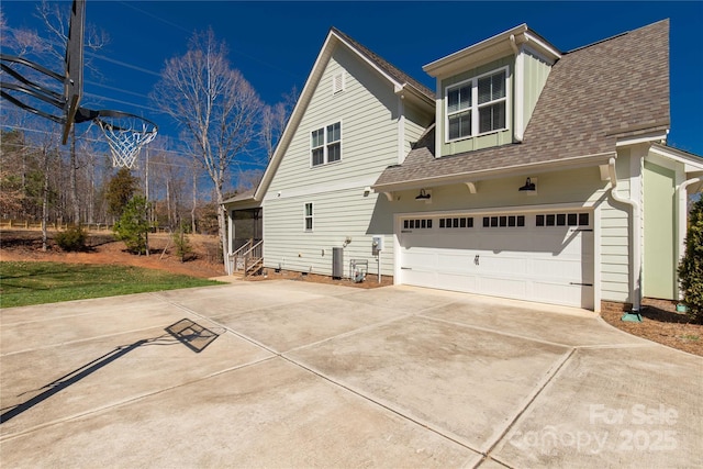 view of home's exterior with driveway and a shingled roof