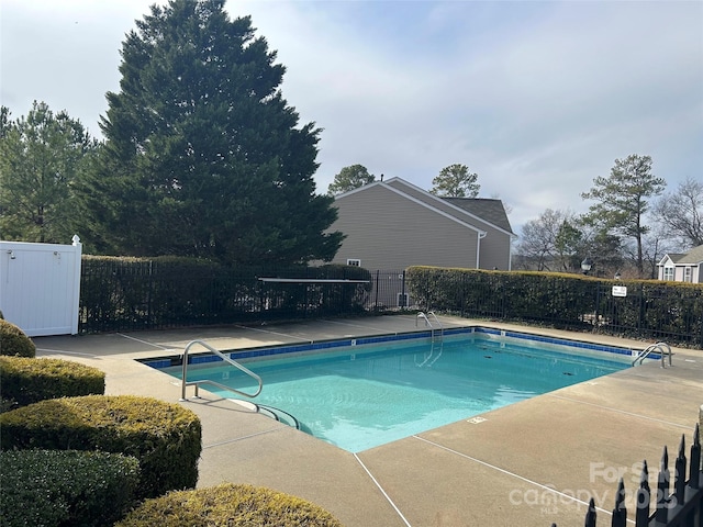 pool featuring a patio and fence