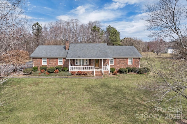 single story home with a chimney, brick siding, covered porch, and a front lawn