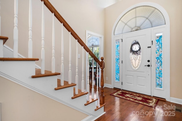 entryway featuring baseboards and hardwood / wood-style flooring