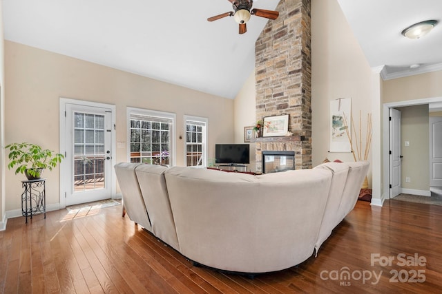 living area with a fireplace, high vaulted ceiling, dark wood-type flooring, and baseboards