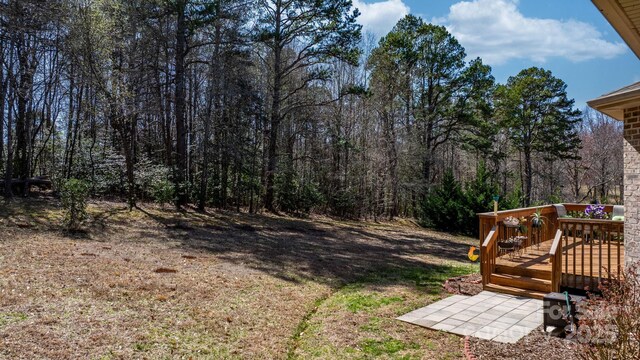 3815 10th St NE, Hickory, NC 28601 - view of yard featuring a deck and a forest view