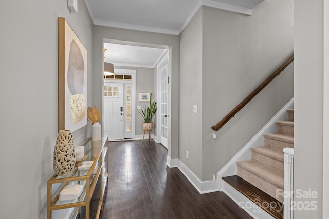 entryway with hardwood / wood-style floors, stairs, baseboards, and ornamental molding