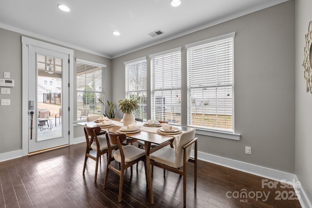 dining space featuring dark wood finished floors, plenty of natural light, and baseboards