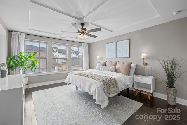 bedroom with visible vents, wood finished floors, baseboards, and ceiling fan