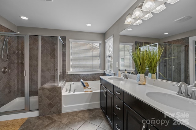 bathroom featuring a bath, a shower stall, and a sink