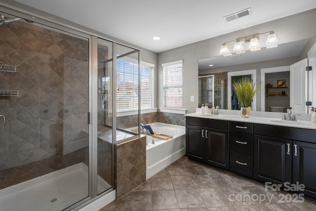 full bath with a shower stall, a bath, visible vents, and a sink