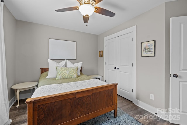 bedroom with a closet, baseboards, a ceiling fan, and dark wood-style flooring