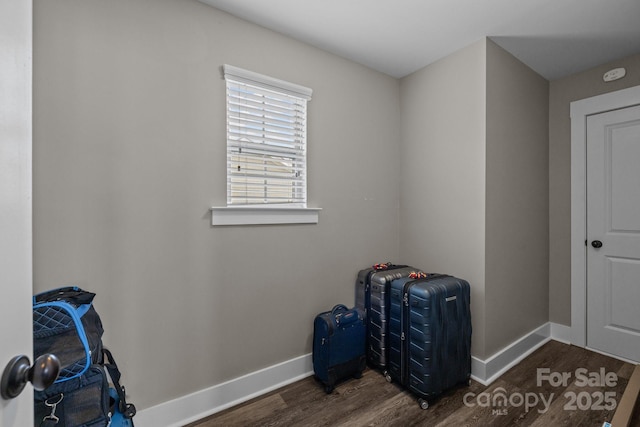 interior space with baseboards and wood finished floors