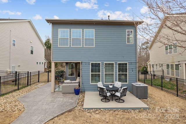 rear view of property featuring cooling unit, a patio, and a fenced backyard