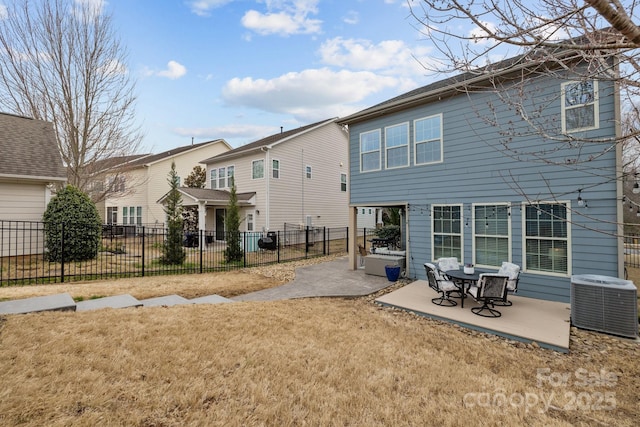 rear view of property featuring a yard, fence, central AC unit, and a patio area