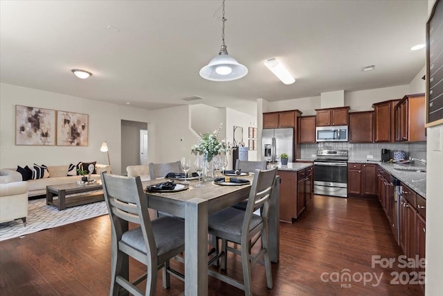 dining area featuring dark wood-style floors and visible vents