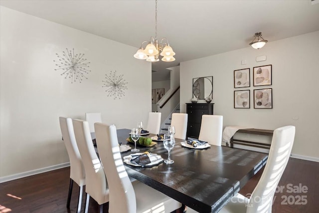 dining room with baseboards, a notable chandelier, wood finished floors, and stairs