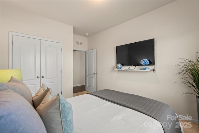 bedroom with visible vents and a closet