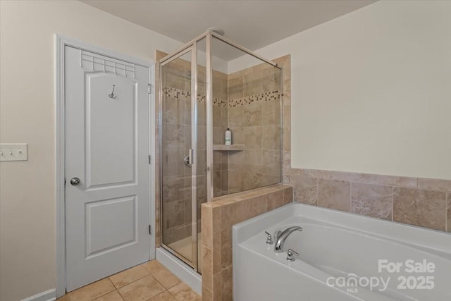 bathroom with a shower stall, a garden tub, and tile patterned floors