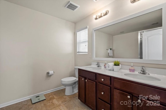 full bath featuring double vanity, visible vents, toilet, and a sink