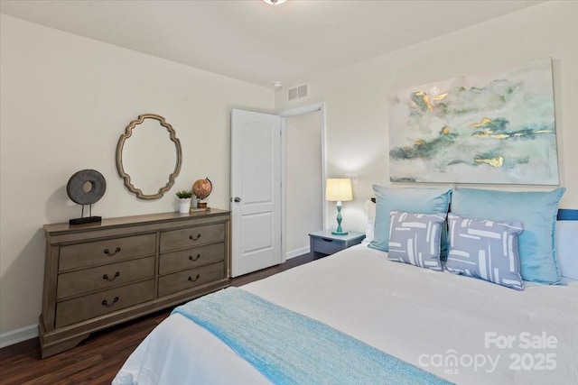 bedroom with visible vents, baseboards, and dark wood-style flooring