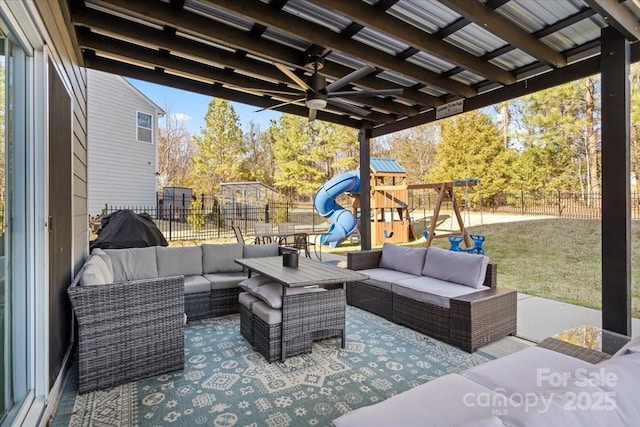 view of patio / terrace featuring an outdoor living space, a fenced backyard, ceiling fan, and a playground