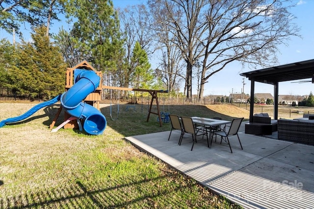 view of jungle gym with a patio area, fence, and a lawn