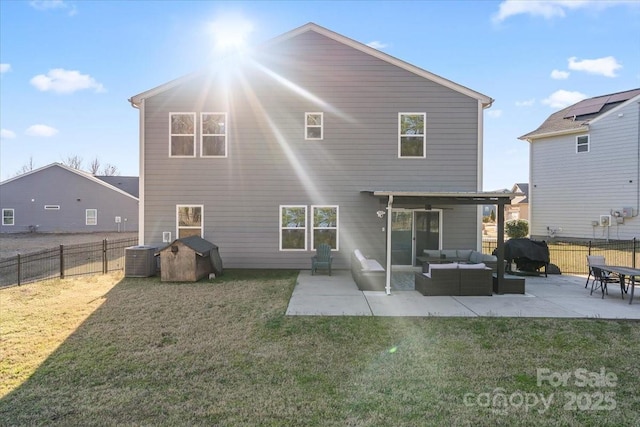 back of property with an outdoor living space, a patio, a lawn, and a fenced backyard