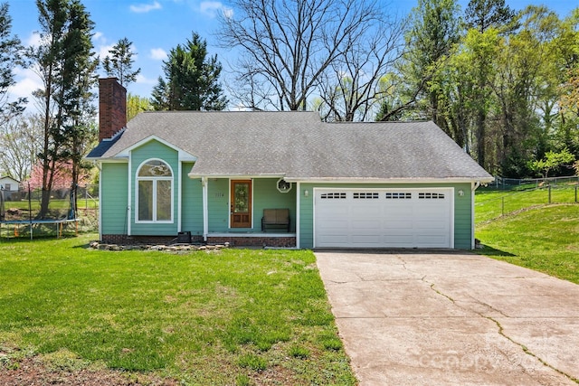 ranch-style home featuring an attached garage, a trampoline, fence, a front lawn, and driveway