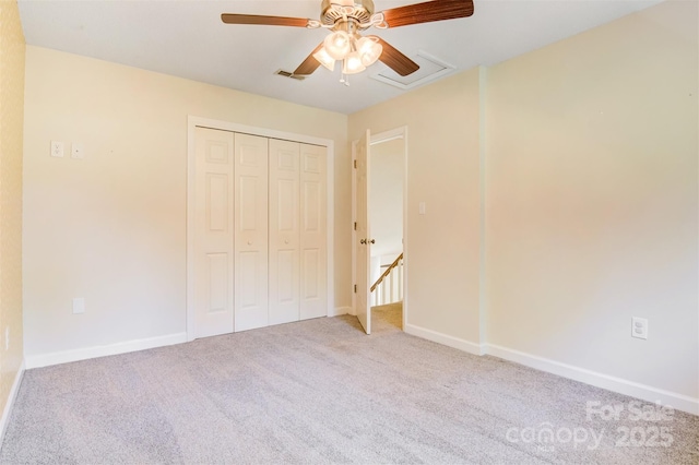 unfurnished bedroom with a closet, visible vents, baseboards, and carpet