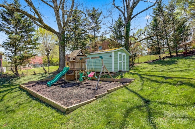 view of jungle gym with a shed, an outdoor structure, fence, and a lawn