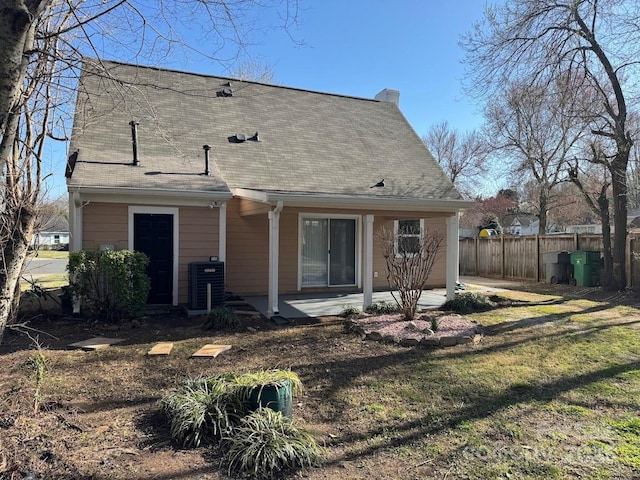 back of property featuring a patio, cooling unit, fence, and a chimney