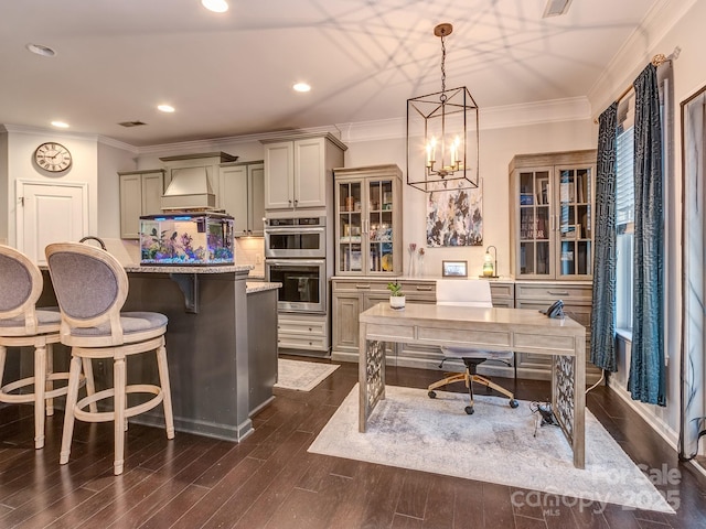 kitchen with stainless steel double oven, a kitchen bar, tasteful backsplash, and crown molding