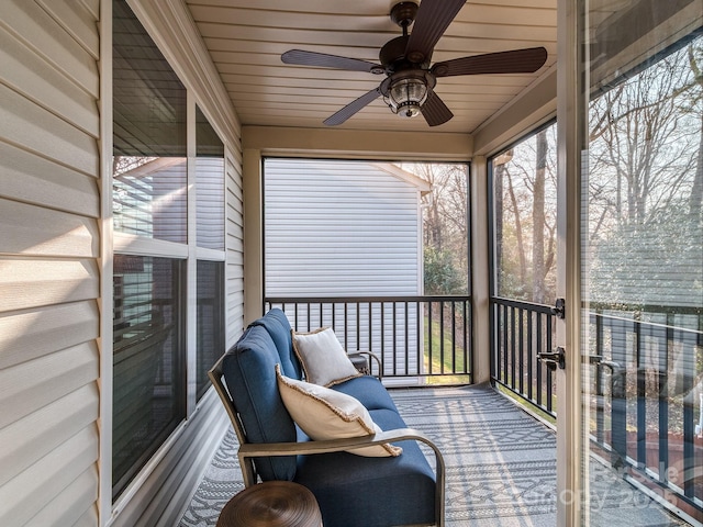 sunroom / solarium featuring ceiling fan