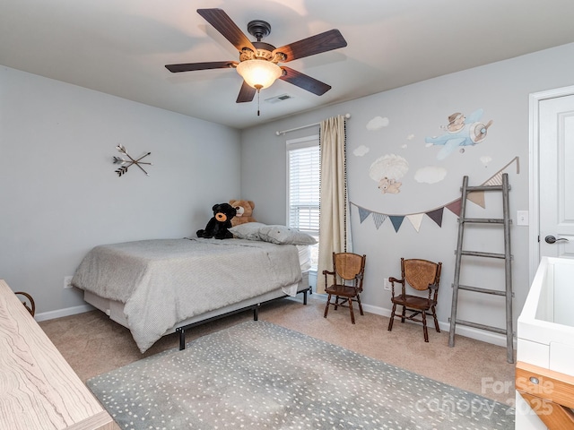 carpeted bedroom featuring visible vents, a ceiling fan, and baseboards