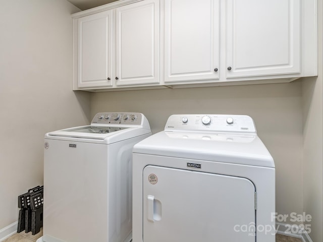 washroom featuring cabinet space and separate washer and dryer