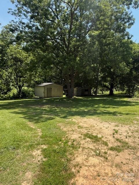 5949 Flat Creek Rd, Kershaw, SC 29067 - view of green lawn featuring a storage unit