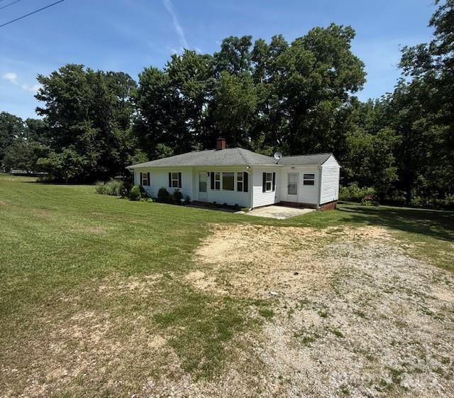5949 Flat Creek Rd, Kershaw, SC 29067 - back of house with a lawn and a chimney