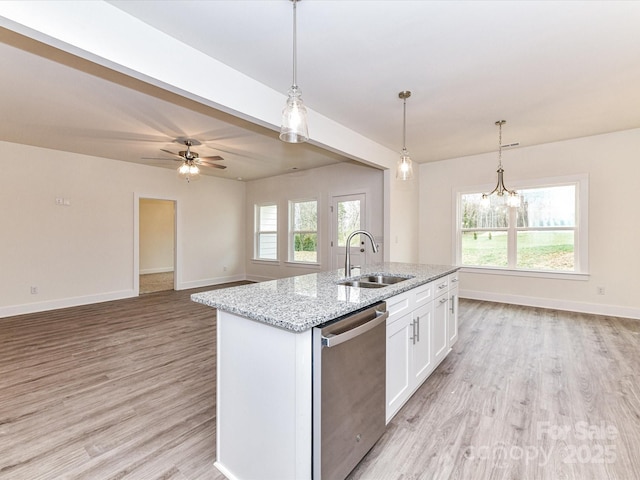 kitchen with dishwasher, an island with sink, light wood-style floors, white cabinetry, and a sink